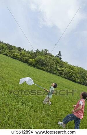Picture - Children running with net. Fotosearch