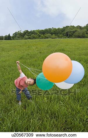 Girl holding balloons View Large Photo Image Stock Photo - Girl holding balloons. Fotosearch