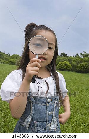 Girl holding magnifying glass View Large Photo Image Stock Photo - Girl holding magnifying glass. Fotosearch
