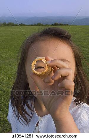 Stock Image - Girl looking through cone. Fotosearch