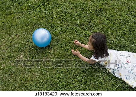 Stock Photo - Girl lying on grass. Fotosearch