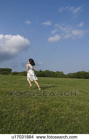 Girl running on grass View Large Photo Image Picture - Girl running on grass. Fotosearch