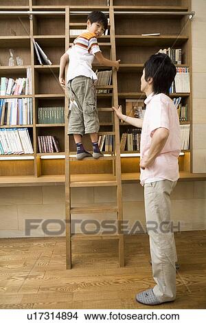 Boy climbing up ladder View Large Photo Image Picture - Boy climbing up ladder. Fotosearch