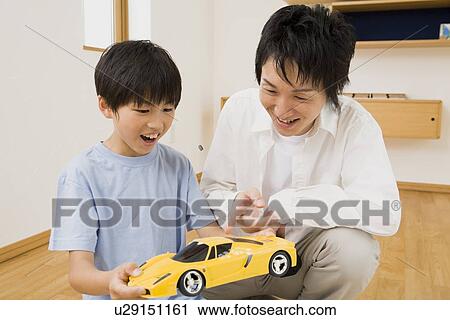 Boy holding toy car View Large Photo Image Stock Image - Boy holding toy car. Fotosearch