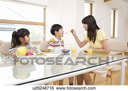 Family eating breakfast View Large Photo Image Stock Photo - Family eating breakfast. Fotosearch