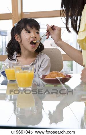 Family eating breakfast View Large Photo Image Stock Photography - Family eating breakfast. Fotosearch