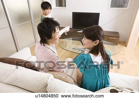 Stock Image - Family playing with video game. Fotosearch