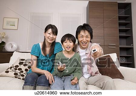 Stock Image - Family playing with video game. Fotosearch