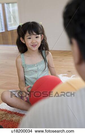 Girl holding cushion View Large Photo Image Picture - Girl holding cushion. Fotosearch