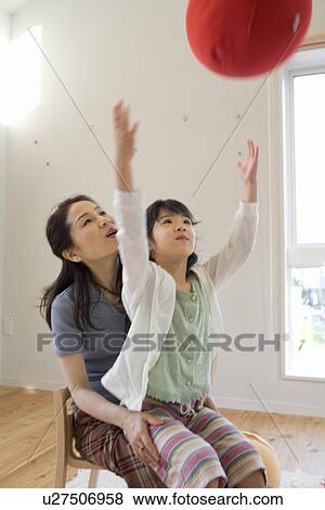 Girl throwing cushion View Large Photo Image Stock Photo - Girl throwing cushion. Fotosearch