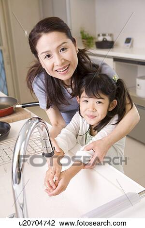 Girl washing hands with grandmother View Large Photo Image Stock Image - Girl washing hands with grandmother. Fotosearch