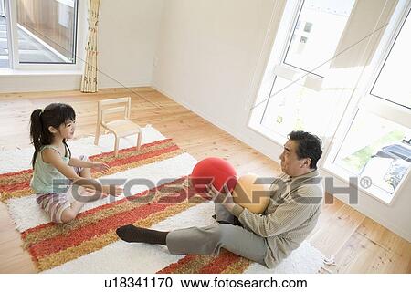 Stock Image - Grandfather and girl playing. Fotosearch