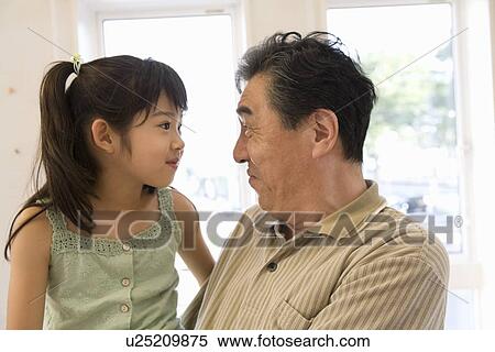 Stock Photography - Grandfather starting at granddaughter. Fotosearch