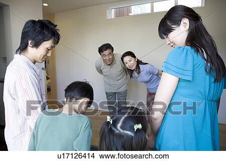 Picture - Grandparents welcoming grandchildren. Fotosearch