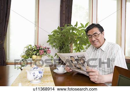 Picture - Mature man reading newspaper. Fotosearch