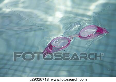 Swimming goggles floating in pool View Large Photo Image Stock Photo - Swimming goggles floating in pool. Fotosearch