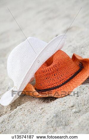 Two straw hats at beach View Large Photo Image Stock Photo - Two straw hats at beach. Fotosearch