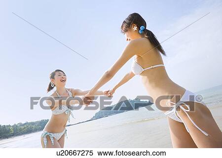 Two young women holding hands View Large Photo Image Stock Photography - Two young women holding hands. Fotosearch