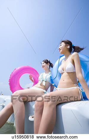 Stock Photo - Two young women in bikini. Fotosearch