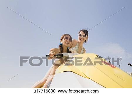 Two young women jet-skiing View Large Photo Image Stock Image - Two young women jet-skiing. Fotosearch