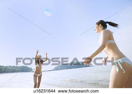 Two young women playing with beach ball View Large Photo Image Picture - Two young women playing with beach ball. Fotosearch