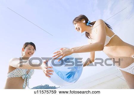 Two young women playing with beach ball View Large Photo Image Stock Photo - Two young women playing with beach ball. Fotosearch