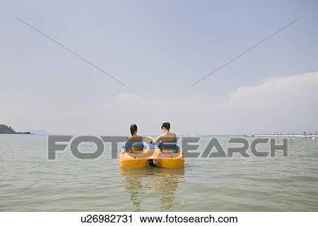 Two young women riding on pedal boat View Large Photo Image Stock Image - Two young women riding on pedal boat. Fotosearch