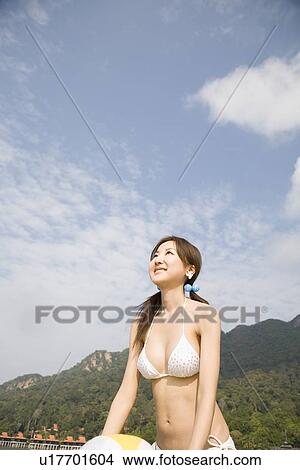 Young woman holding with beach ball View Large Photo Image Picture - Young woman holding with beach ball. Fotosearch