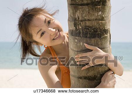Stock Photo - Young woman in bikini smiling. Fotosearch