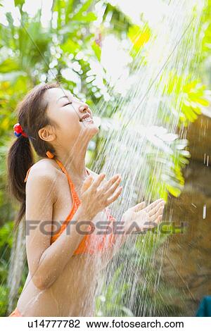 Young woman in bikini taking shower View Large Photo Image Stock Image - Young woman in bikini taking shower. Fotosearch