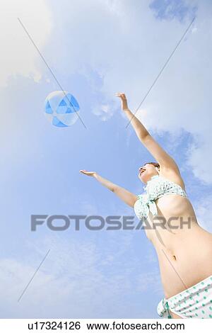Young woman playing with beach ball View Large Photo Image Stock Photograph - Young woman playing with beach ball. Fotosearch