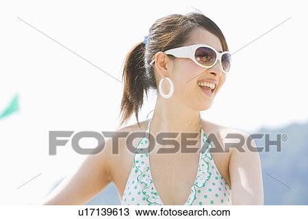 Young woman wearing bikini View Large Photo Image Stock Image - Young woman wearing bikini. Fotosearch