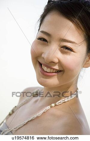 Stock Photograph - Portrait of young woman smiling. Fotosearch