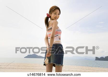 Young woman holding seashell View Large Photo Image Picture - Young woman holding seashell. Fotosearch