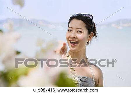 Stock Photograph - Young woman pointing. Fotosearch