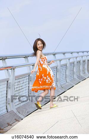 Stock Image - Young woman running. Fotosearch