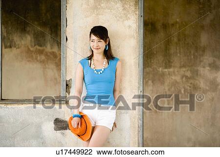 Stock Image - Young woman standing. Fotosearch
