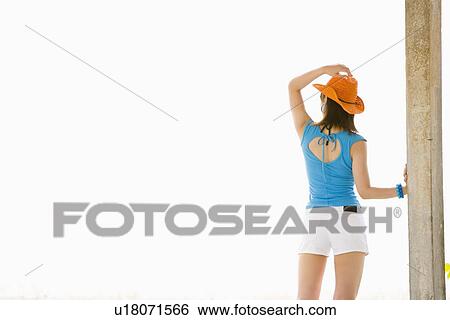 Stock Photograph - Young woman standing. Fotosearch
