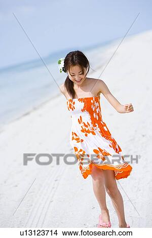 Young woman walking at beach View Large Photo Image Picture - Young woman walking at beach. Fotosearch