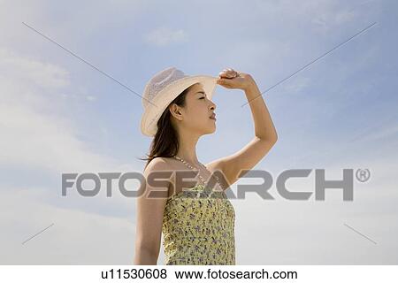Stock Photo - Young woman wearing hat. Fotosearch