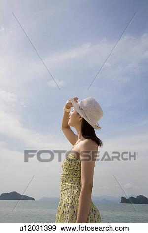 Stock Photo - Young woman wearing hat. Fotosearch