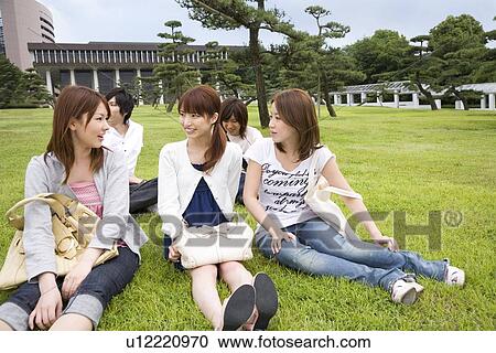 College students sitting on lawn View Large Photo Image Stock Image - College students sitting on lawn. Fotosearch