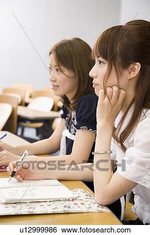 Stock Photograph - College students studying in lecture room. Fotosearch
