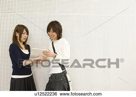 Two college students talking View Large Photo Image Stock Photograph - Two college students talking. Fotosearch