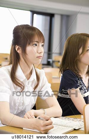 Two young women studying at college View Large Photo Image Stock Image - Two young women studying at college. Fotosearch