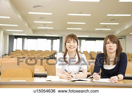 Two young women studying at college View Large Photo Image Stock Photograph - Two young women studying at college. Fotosearch