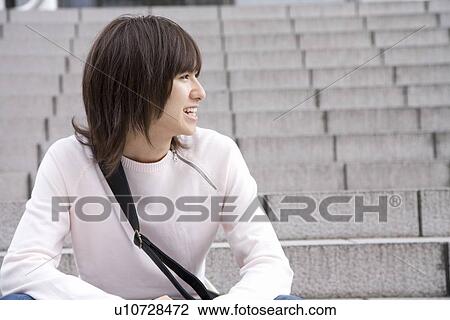 Young man sitting on steps View Large Photo Image Stock Image - Young man sitting on steps. Fotosearch