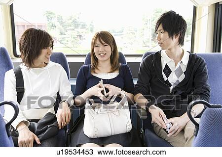 Young men and woman talking in bus View Large Photo Image Stock Image - Young men and woman talking in bus. Fotosearch
