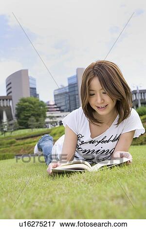 Stock Photo - Young woman reading book. Fotosearch