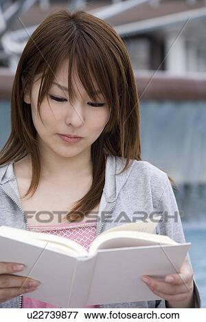 Young woman reading book View Large Photo Image Stock Photo - Young woman reading book. Fotosearch